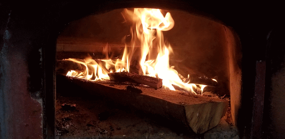 Animation of fire roaring inside a pizza oven.